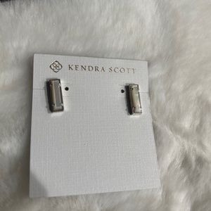 Kendra Scott white stud earrings.
